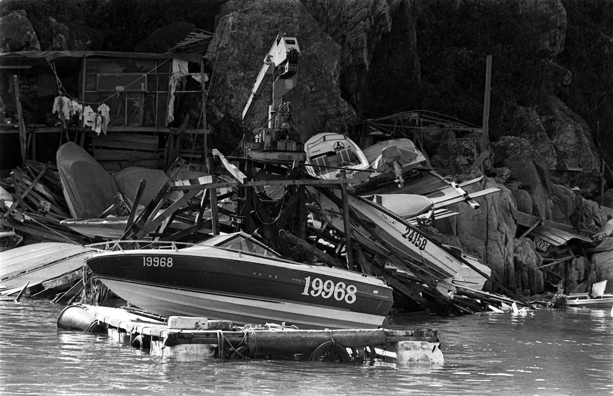 Wrecked speedboats lay piled up after being tossed onto the rocks by crashing waves