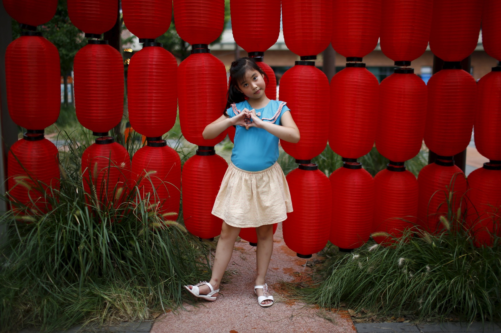 Liang Xiao, who was born in 2007, poses for a photograph in Shanghai August 24, 2014. 'I want a little sister because little brothers are naughty,' Xiao said.