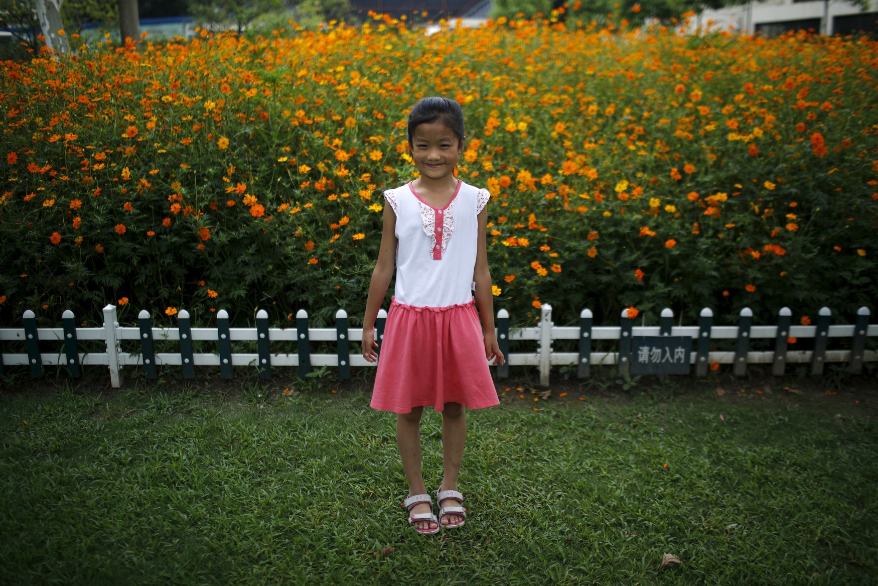 Liu Yuwei, who was born in 2006, poses for a photograph in Shanghai August 16, 2014. Yuwei said she would like siblings 'because I want to play with them.'