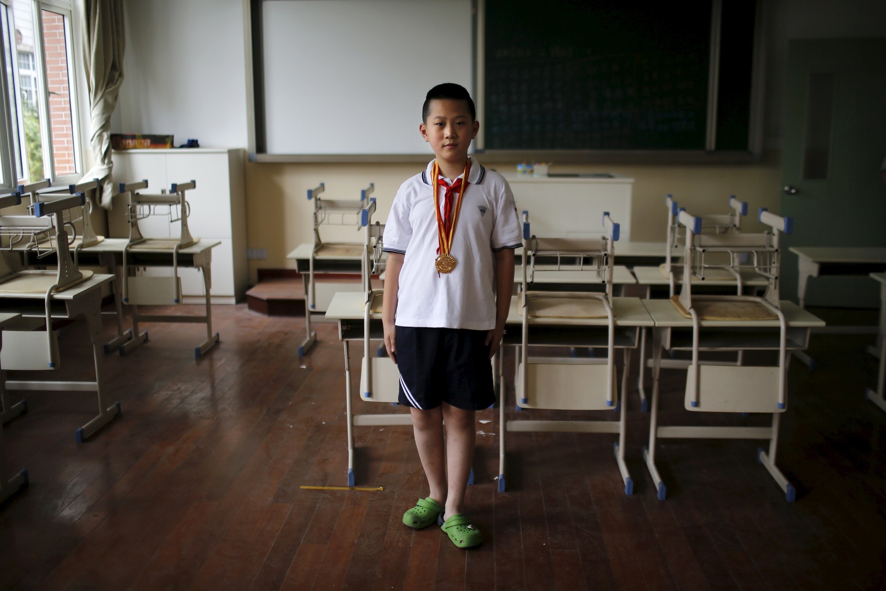 Only child Wang Qi'an, who was born in 2003, poses for a photograph in Shanghai August 15, 2014. When asked if he would like to have siblings, Qi'an said: 'No because I have investigated all my classmates who have brothers or sisters. None of them perform well in their studies.'