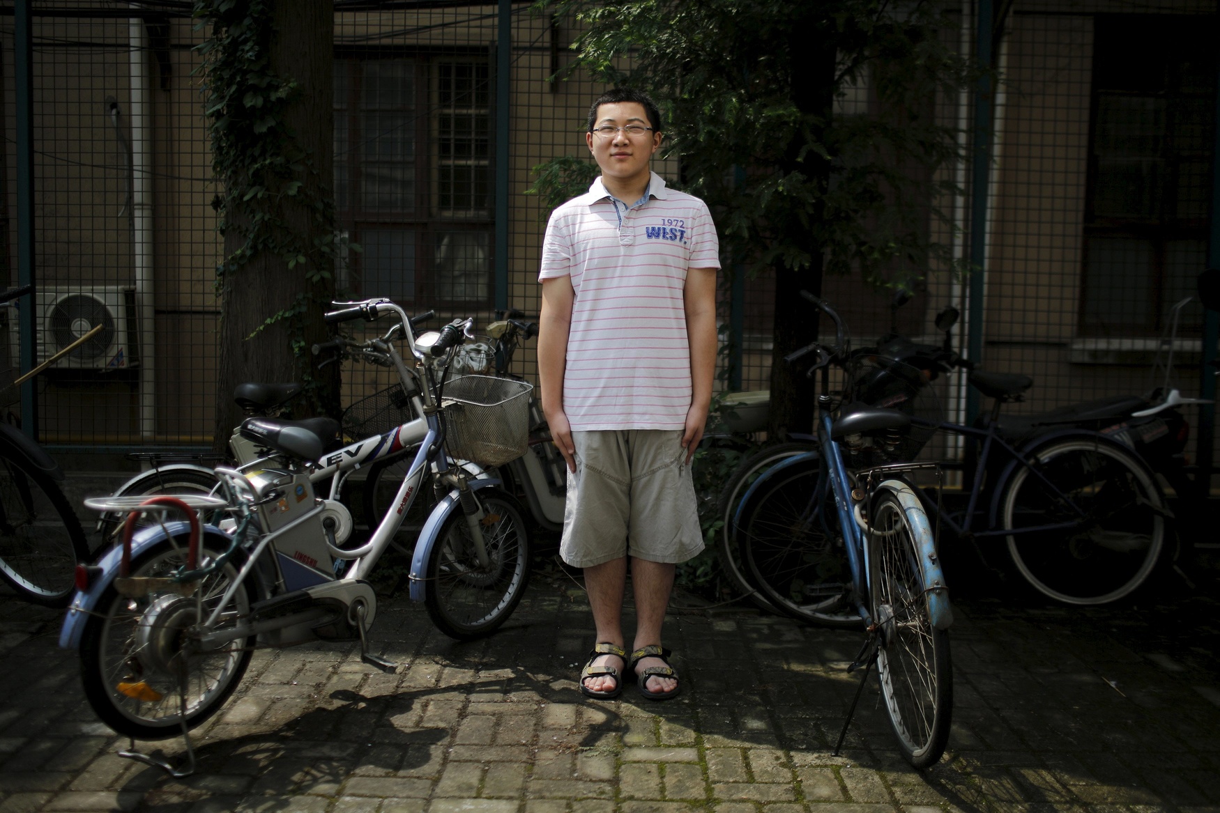 Ding Tieru, who was born in 2002, poses for a photograph in Shanghai July 27, 2014. 'I have a cousin. I'd like to have a brother. Because we would be able to play together. I want more friends. We would be able to help each other in our studies,' said Tieru.
