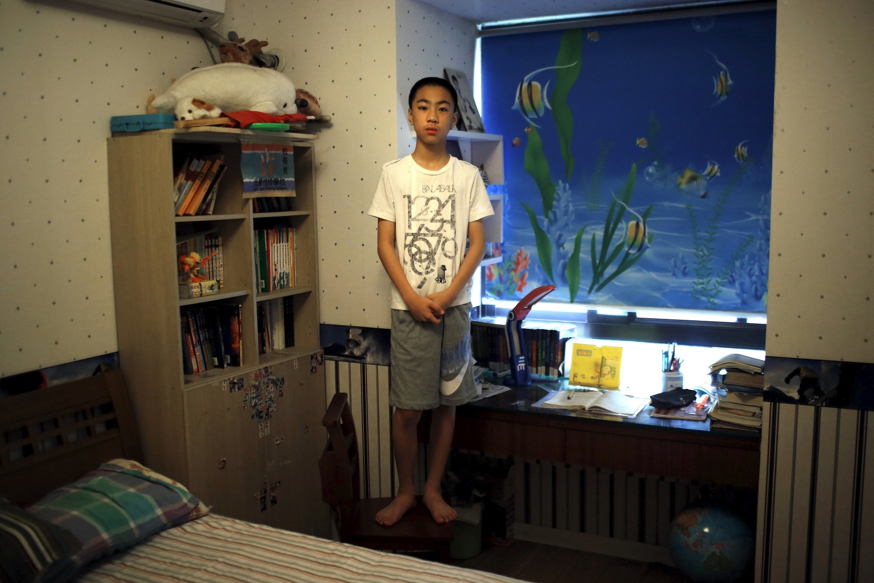 Yao Jihan, who was born in 2000, poses for a photograph in Shanghai July 27, 2014. When asked if he would like siblings Jihan said: 'No. I don't know. Maybe, maybe, because it's troublesome. If there is one more person in this house, the room will not be big enough to hold two children. I don't feel lonely because I have a lot of friends.'