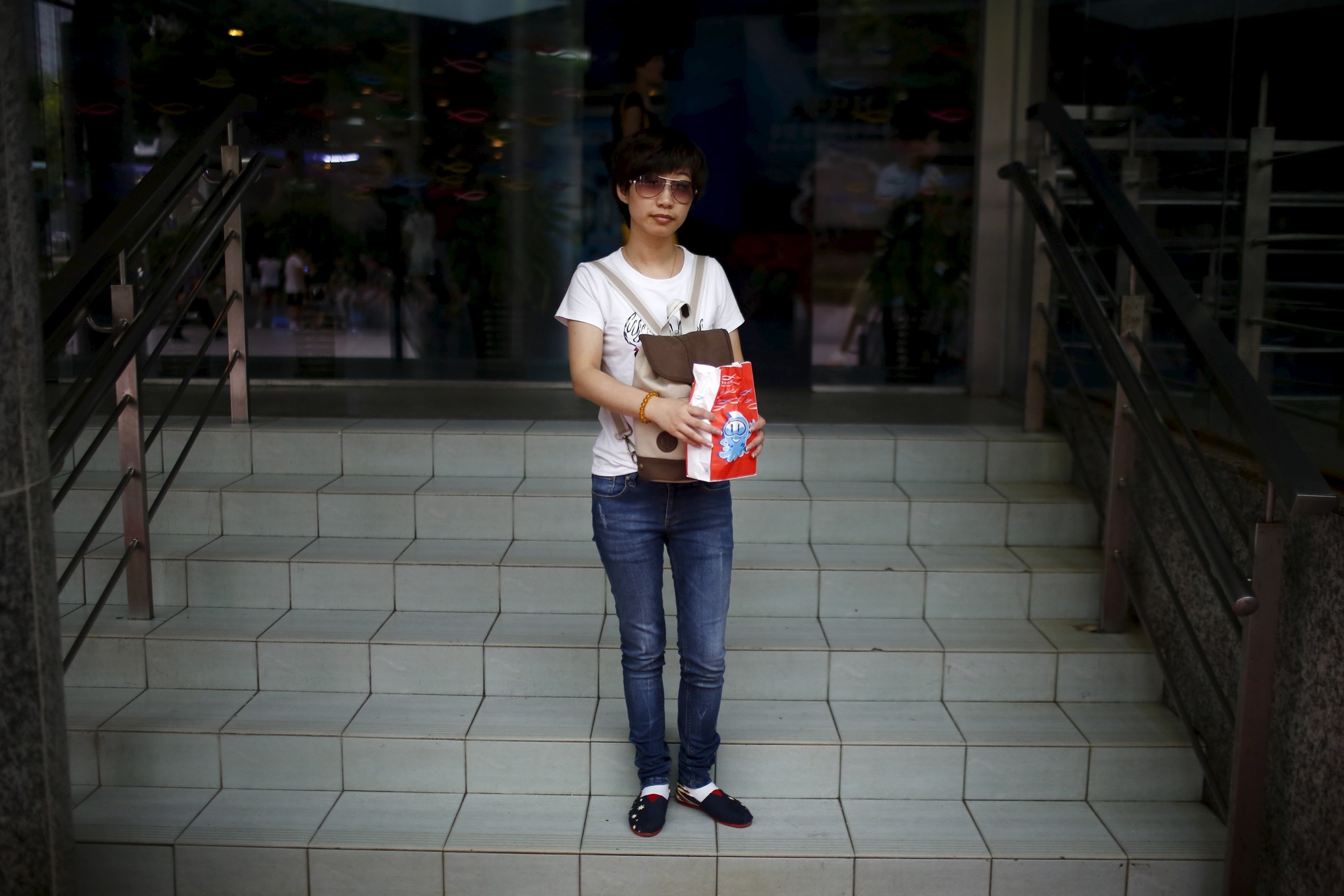 Xu Yufang, who was born in 1982, poses for a photograph in Shanghai August 22, 2014. Yufang said: 'I longed to have a brother to protect me, because I'm alone.'