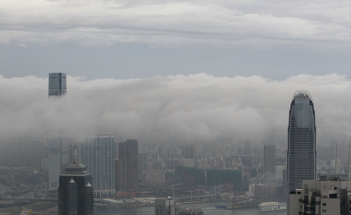 International Commerce Centre in West Kowloon (Left) and International Finance Centre in Central (Right) emerge from clouds after heavy rain